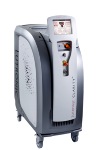 Medical aesthetic device on wheels with a tall control panel and handheld applicator for cosmetic treatments.